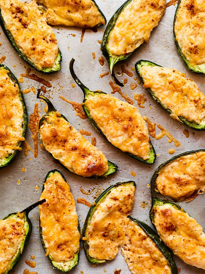 Cheddar baked jalapeño poppers on baking pan.