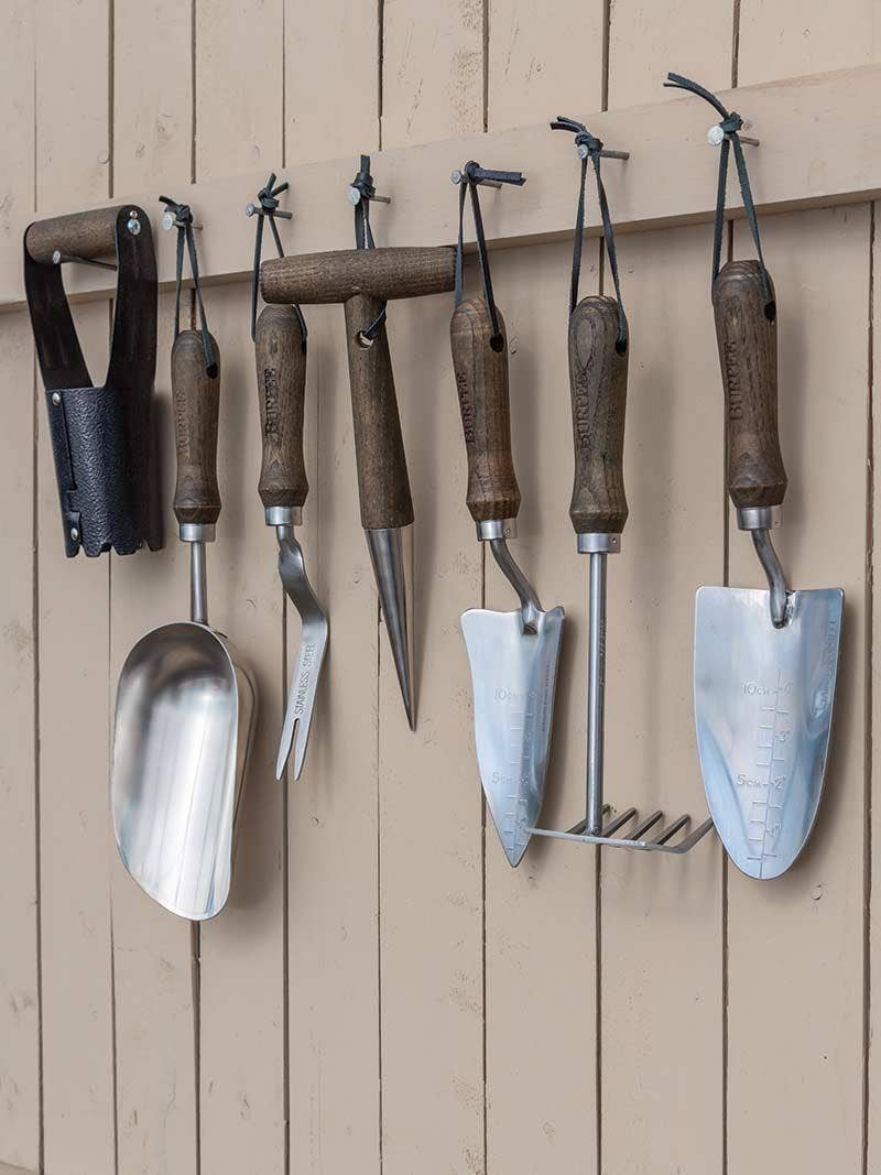 Garden tools hanging on a wall.