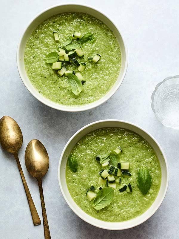 A bowl of Green Gazpacho on table.