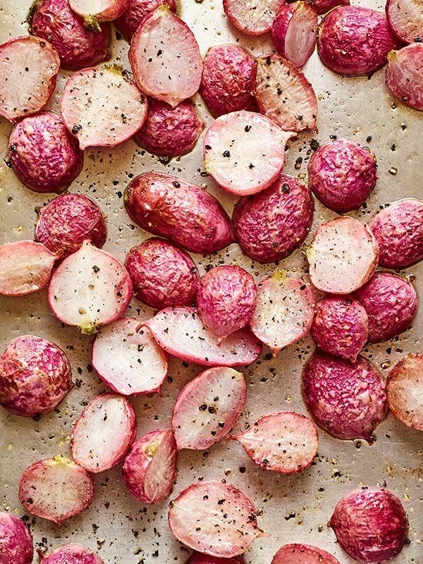 Roasted radishes on a bakeing sheet.