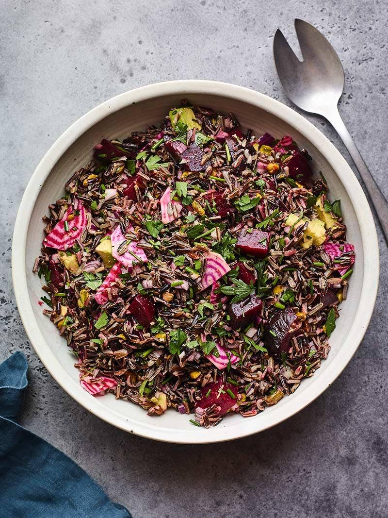 A bowl of wild rice salad on table.